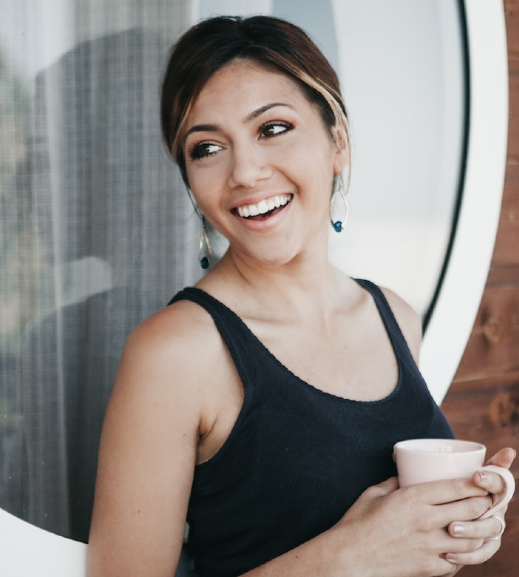 Woman smiling holding coffee