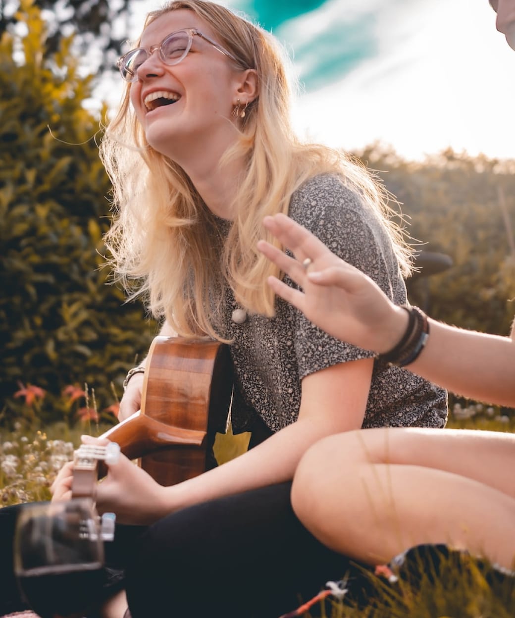 woman smiling playing guitar